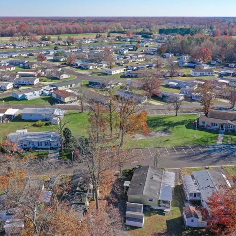 Aerial view Cranberry Run with many homes, large grassy areas and autumn trees