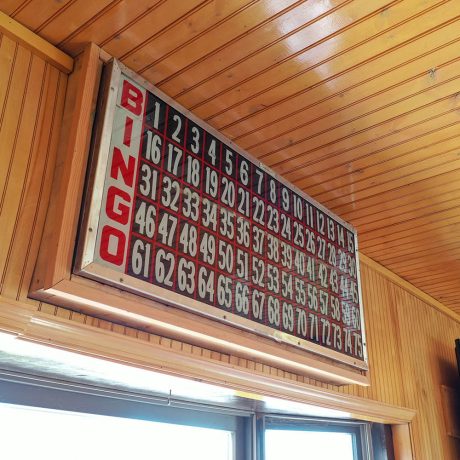 large bingo sign indoors with wood-paneled walls