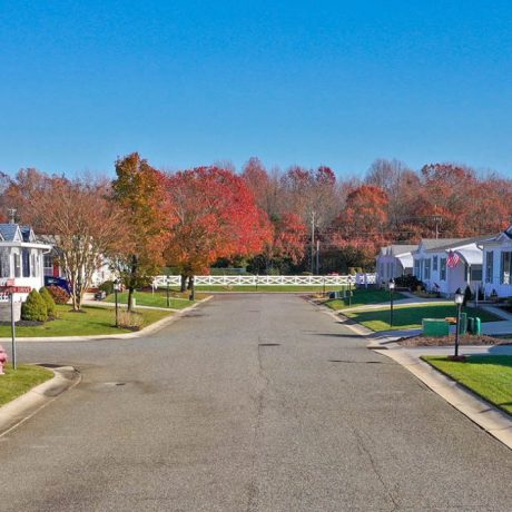 street view of homes, lawns, and autumn trees